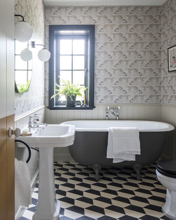 Hex monochrome patterned cement tiles on bathroom floor bathtub